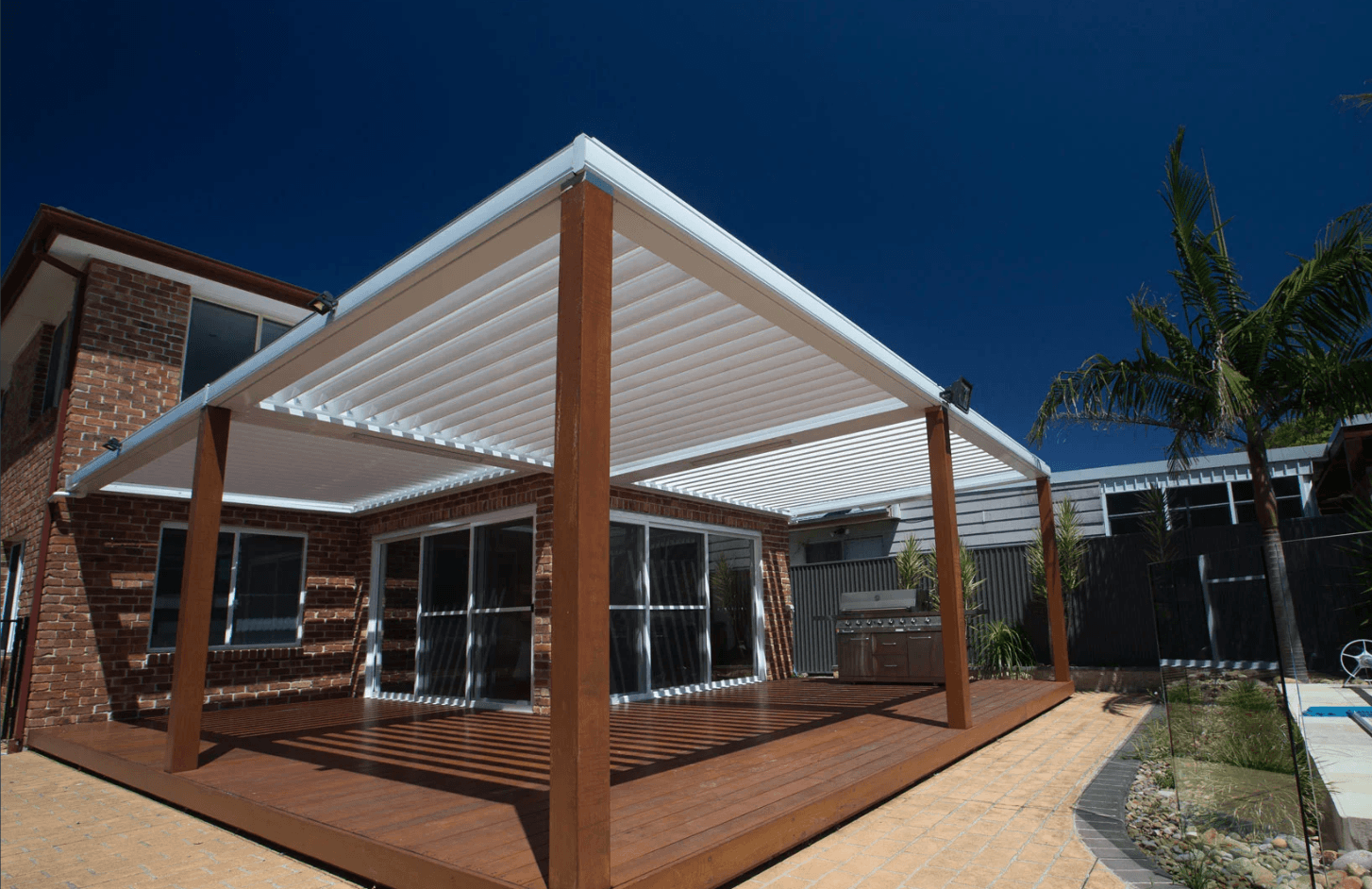 Louvre pergola with timber posts poolside Brighton